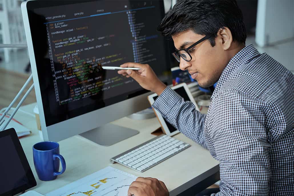 A computer developer inspects his work for code bloat.