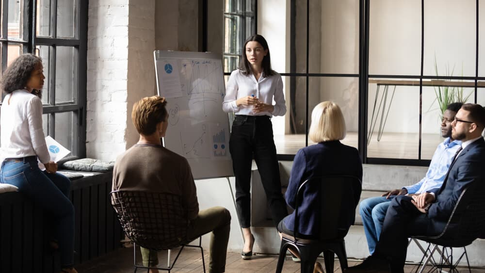 lady business trainer coach leader give flip chart presentation