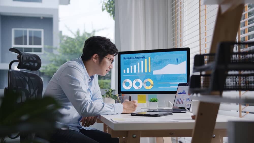 man busy work multiple screen computer