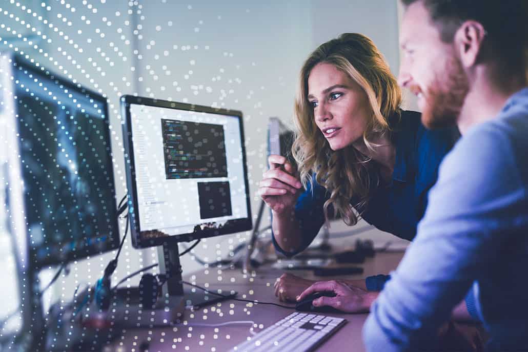 two people working on their desktops