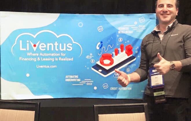 Daniel levin in front of Liventus Banner