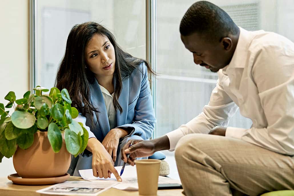 two office employee discussing a project